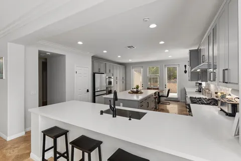 a bathroom with a shower sink vanity and toilet