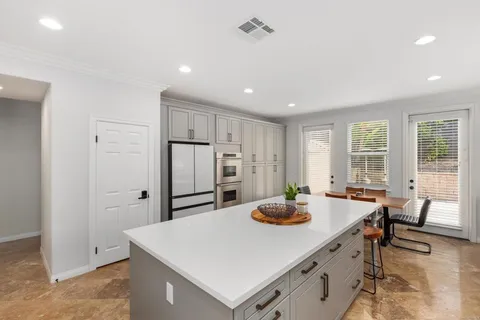 a large windows in a room with a fireplace and cabinet