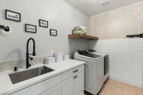 a bathroom with a granite countertop sink a large mirror and a shower
