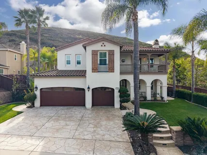 a front view of a house with a garden and a garage