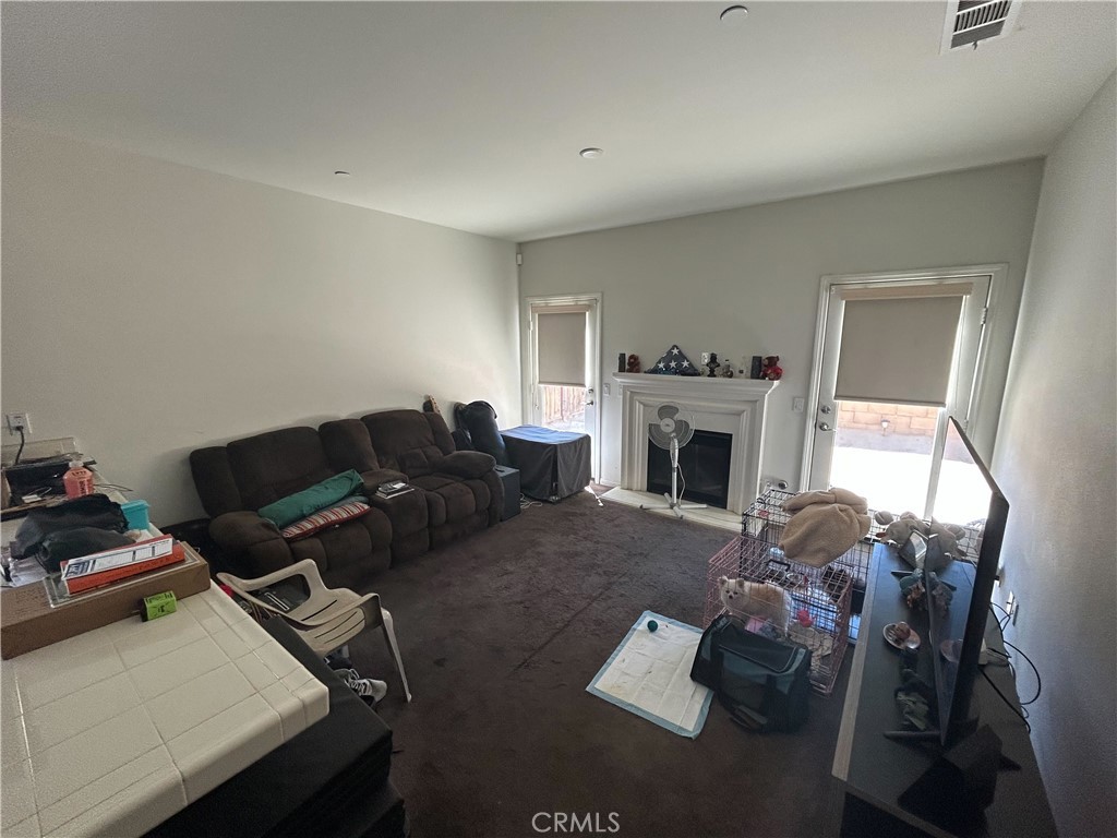 772 St Alban Road San Jacinto, CA 92583 - Photo 13 of 25 a living room with furniture a fireplace and a flat screen tv