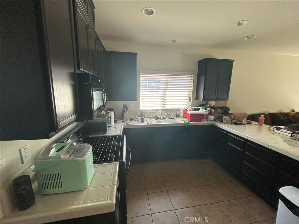 772 St Alban Road San Jacinto, CA 92583 - Photo 10 of 25 a kitchen with a sink cabinets and window