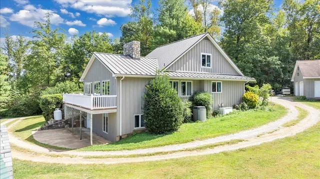 an aerial view of a house with a garden and swimming pool