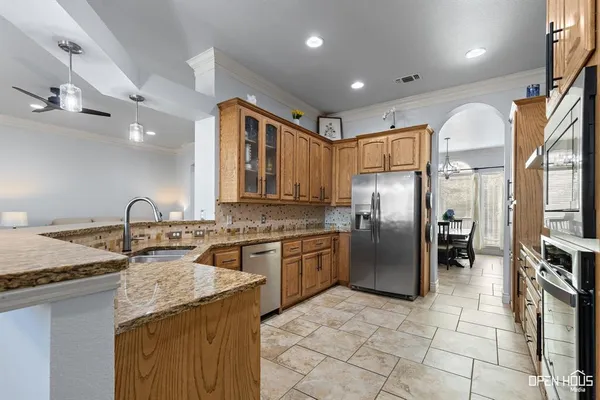 a kitchen with stainless steel appliances granite countertop a sink stove and refrigerator