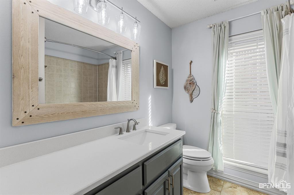 5401 Tanner Drive Wichita Falls, TX 76310 - Photo 22 of 30 a bathroom with a sink a toilet and shower