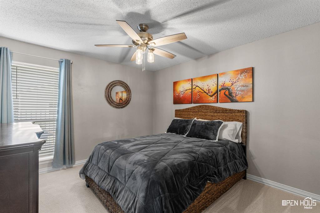 5401 Tanner Drive Wichita Falls, TX 76310 - Photo 24 of 30 a bedroom with a large bed and a chandelier