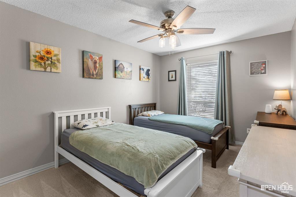 5401 Tanner Drive Wichita Falls, TX 76310 - Photo 25 of 30 a bedroom with a bed and a chandelier