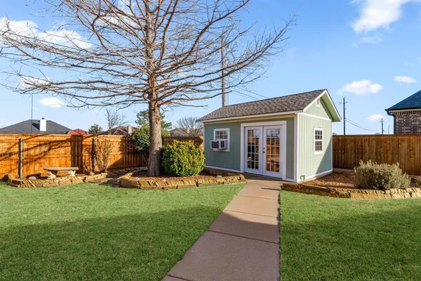 a view of a house with a yard and pathway