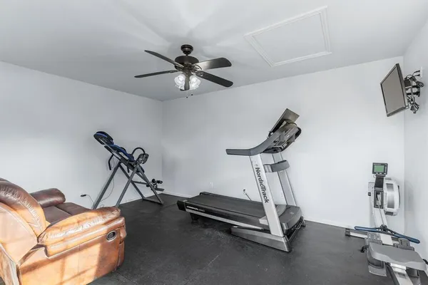 a room with gym equipment and windows