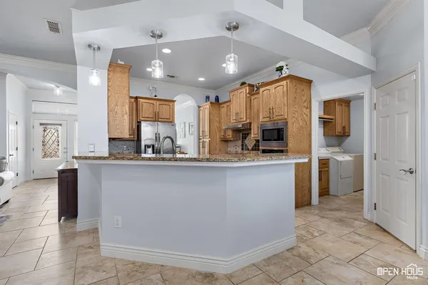 a kitchen with stainless steel appliances a refrigerator sink and cabinets