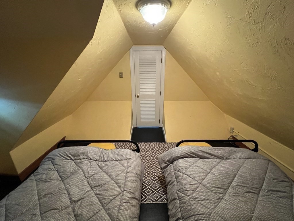 12 State Road, Unit 2E Plymouth, MA 02360 - Photo 19 of 28 a bedroom with a bed and lamp