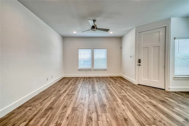 wooden floor in an empty room with a window