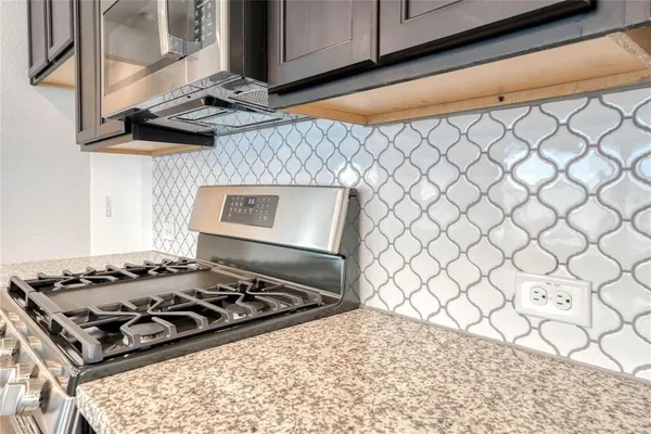 a white stove top oven sitting inside of a kitchen