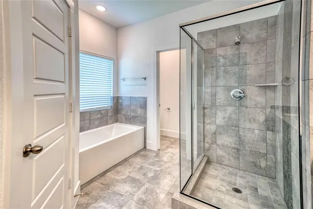 a bathroom with a shower and a bath tub