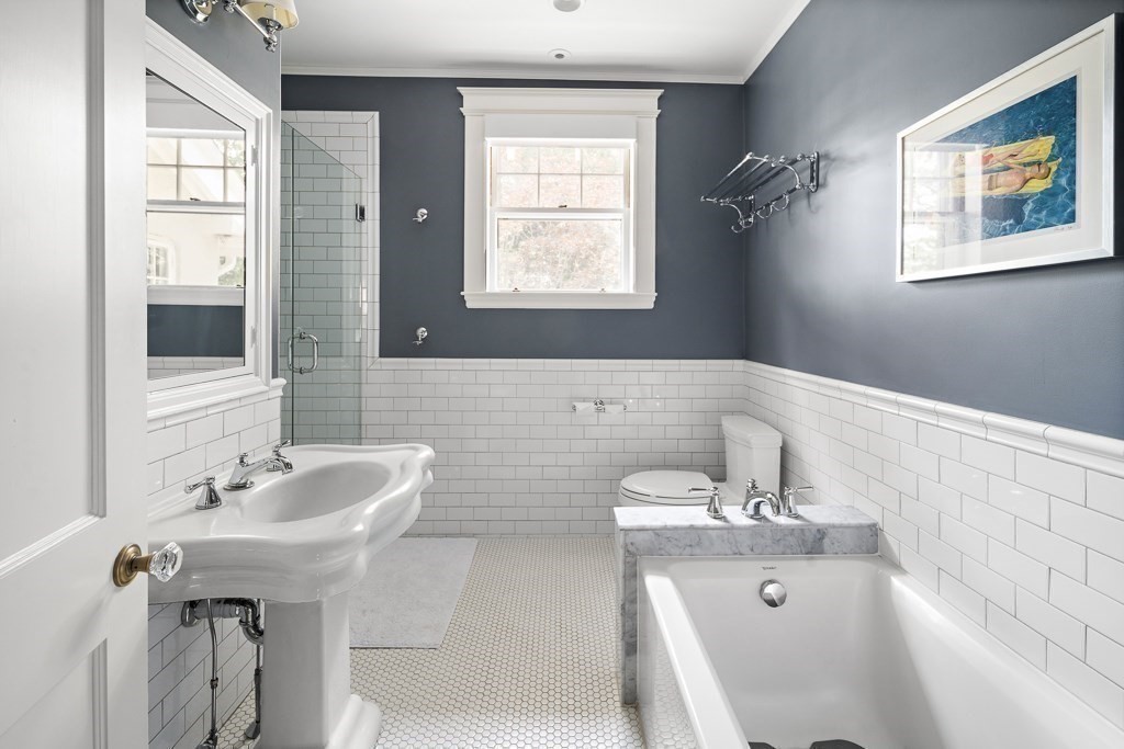 64 Williston Road Brookline, MA 02445 - Photo 18 of 29 a bathroom with a tub sink and mirror