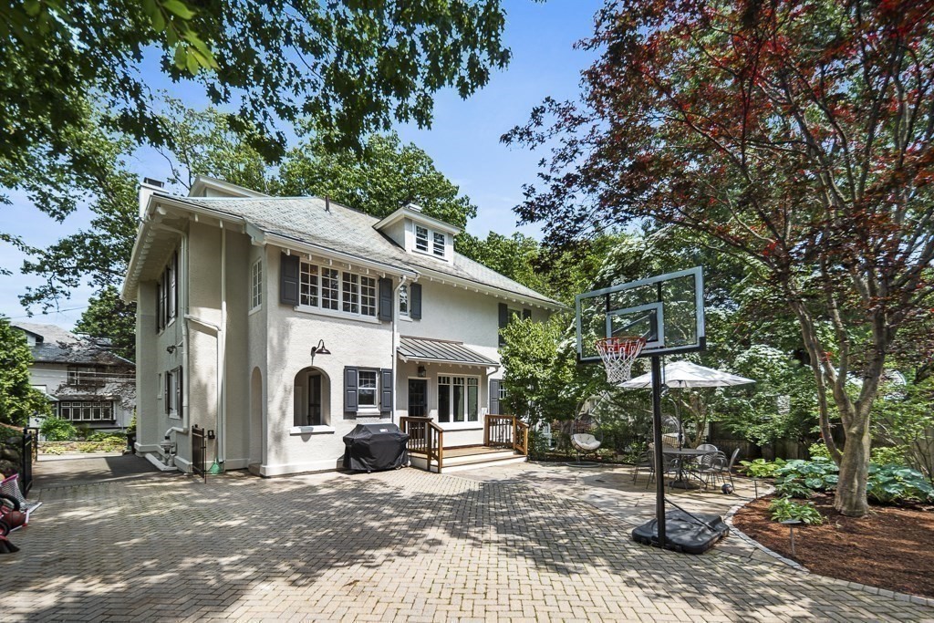 64 Williston Road Brookline, MA 02445 - Photo 27 of 29 a view of a white house with potted plants and large trees