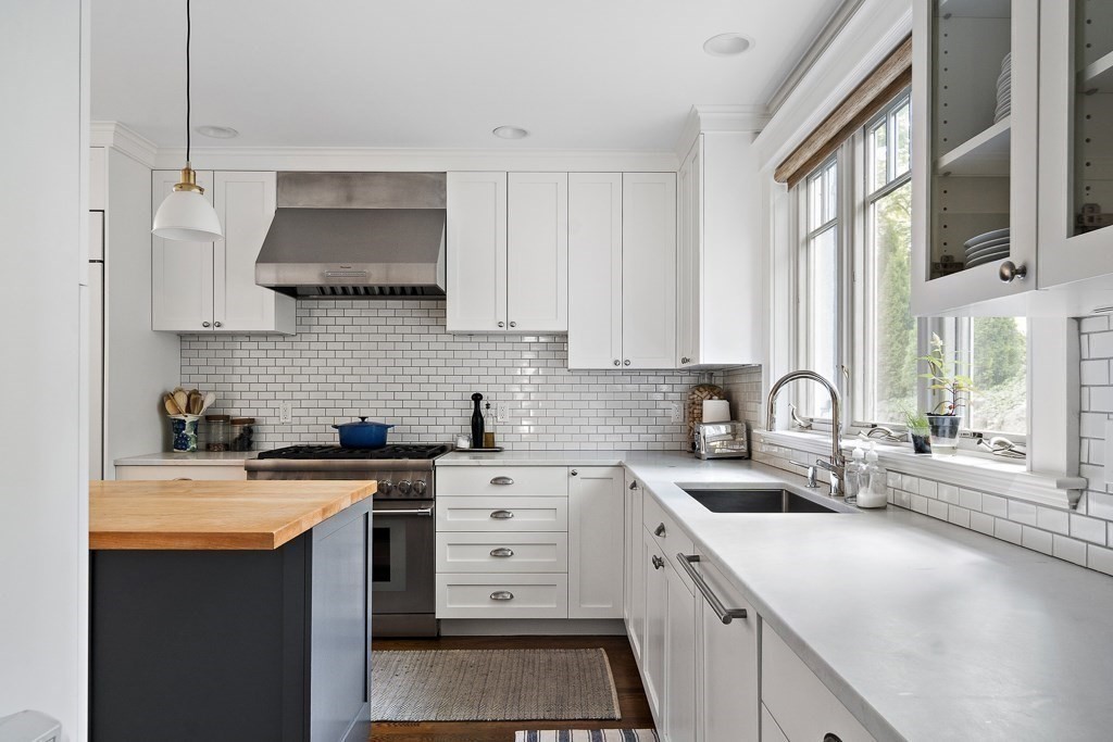 64 Williston Road Brookline, MA 02445 - Photo 7 of 29 a kitchen with stainless steel appliances a sink stove and a window