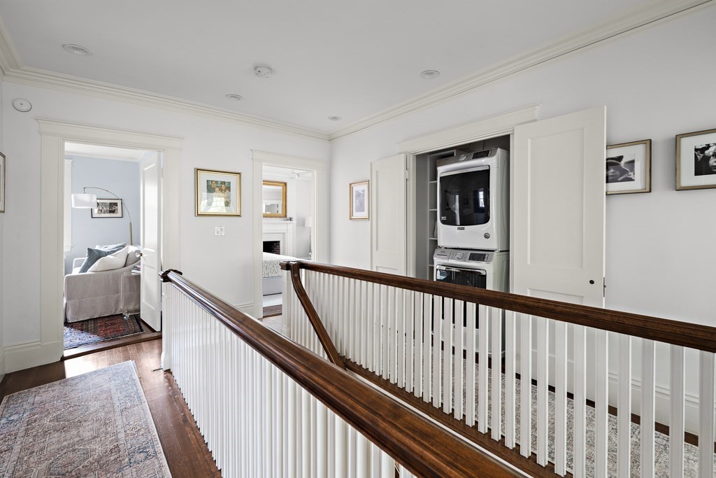 64 Williston Road Brookline, MA 02445 - Photo 10 of 29 a view of a hallway with a livingroom with wooden floor and stairs