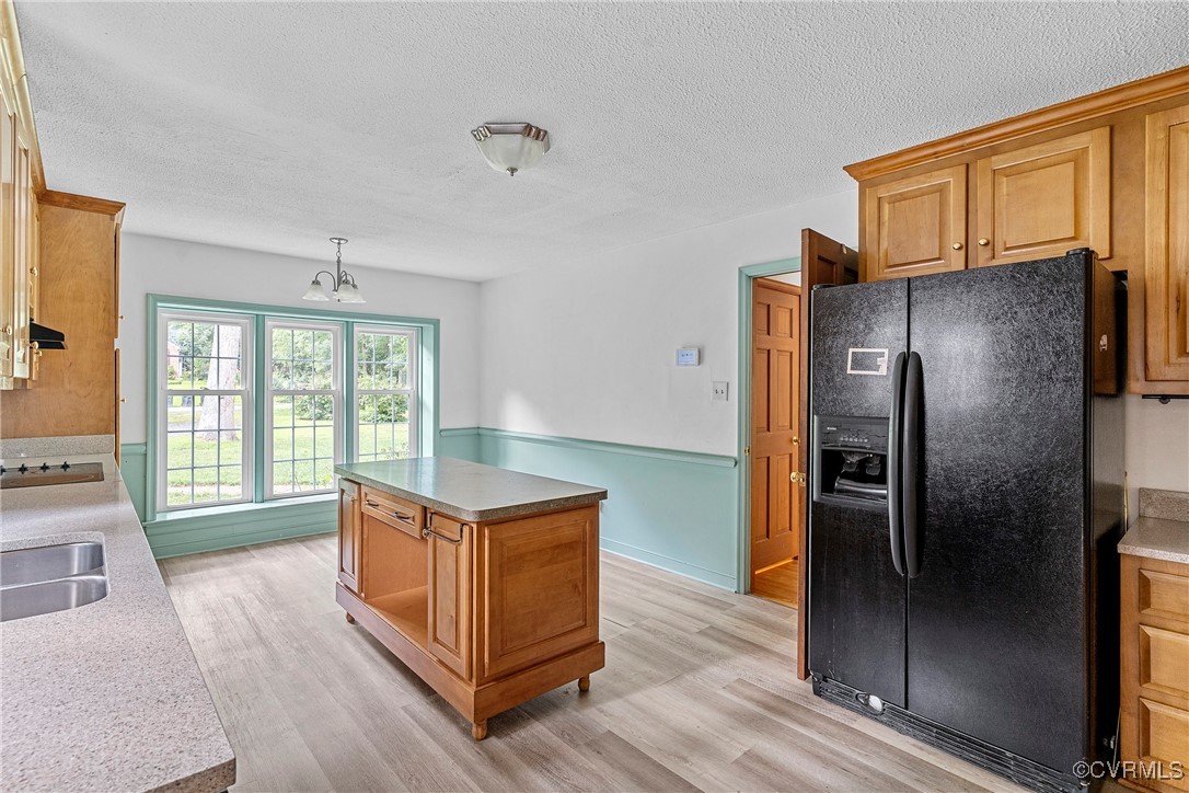 3223 Wood Dale Road Chester, VA 23831 - Photo 11 of 45 Kitchen featuring black fridge, light wood-style f