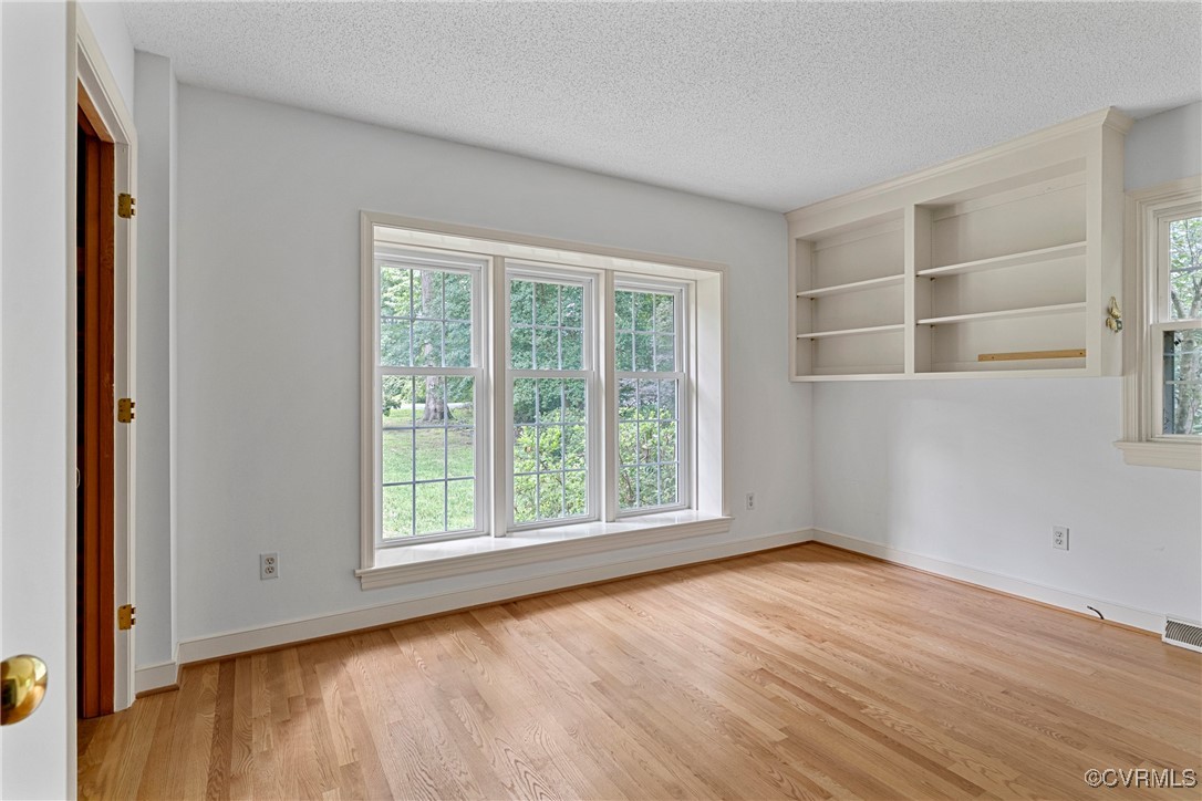 3223 Wood Dale Road Chester, VA 23831 - Photo 20 of 45 Empty room featuring wood finished floors and a te