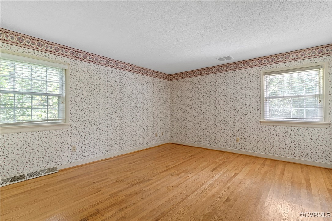 3223 Wood Dale Road Chester, VA 23831 - Photo 24 of 45 Spare room with light wood-style floors, wallpaper