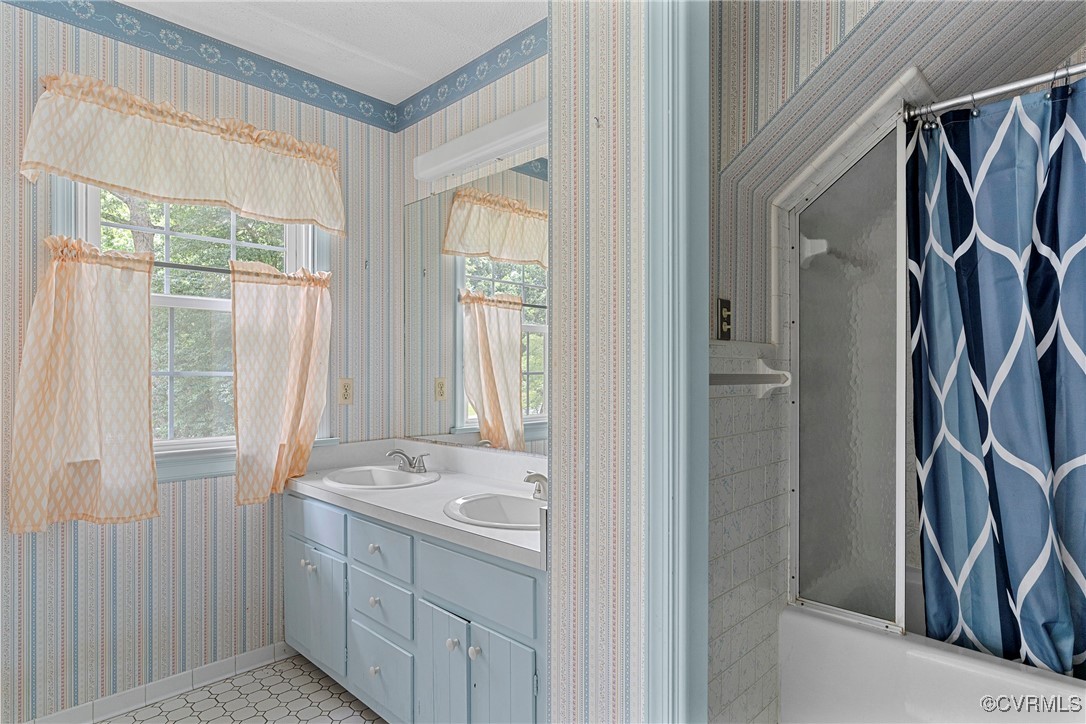 3223 Wood Dale Road Chester, VA 23831 - Photo 39 of 45 Bathroom with wallpapered walls, double vanity, an