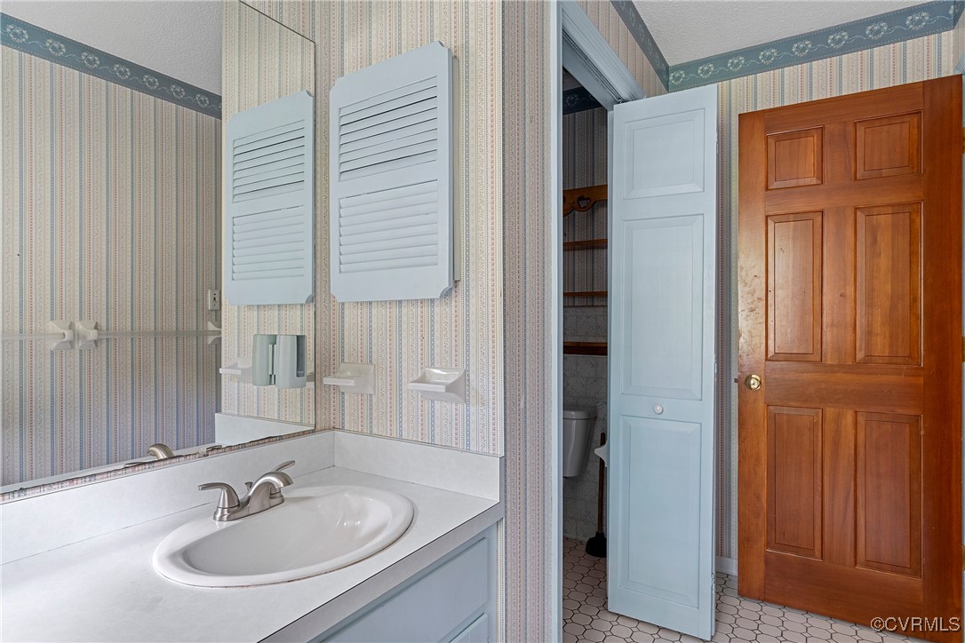 3223 Wood Dale Road Chester, VA 23831 - Photo 40 of 45 Bathroom with wallpapered walls, vanity, and tile
