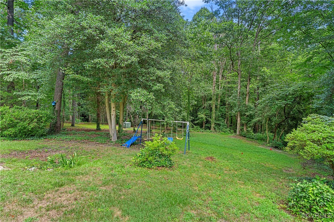 3223 Wood Dale Road Chester, VA 23831 - Photo 45 of 45 View of green lawn featuring a playground and a wo