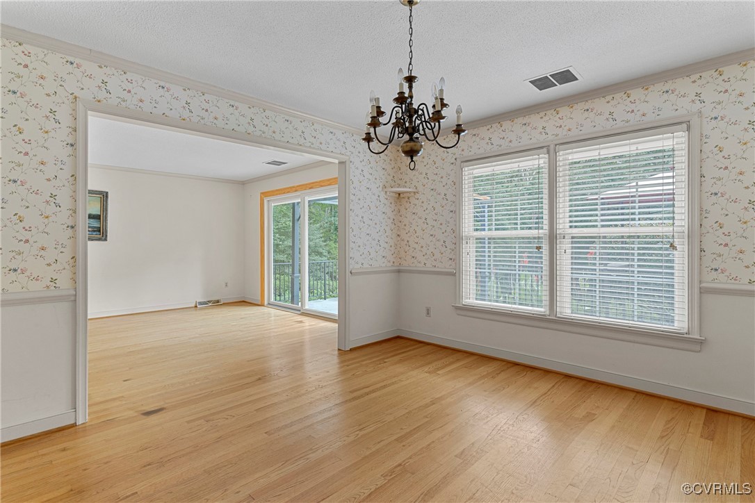 3223 Wood Dale Road Chester, VA 23831 - Photo 10 of 45 Empty room featuring wallpapered walls, a chandeli