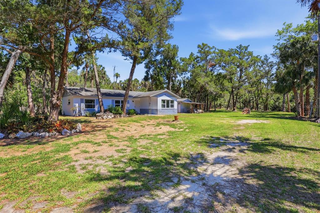 6244 Colony Circle Weeki Wachee, FL 34607 - Photo 28 of 60 a house with swimming pool in front of it