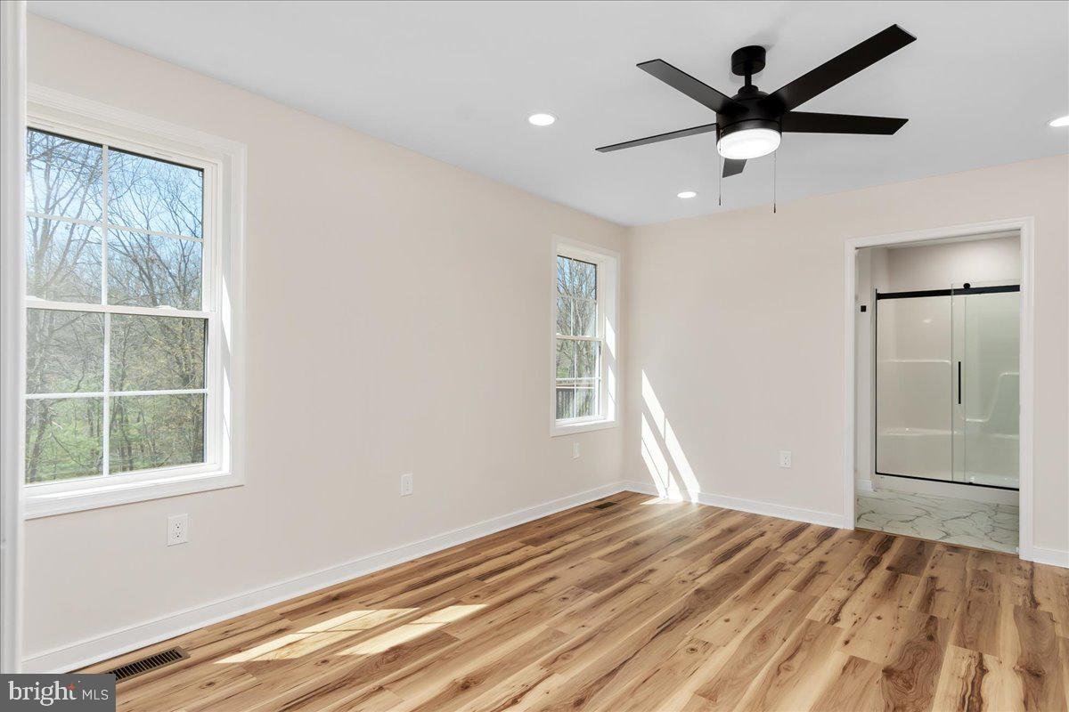 14630 Bain Road Hancock, MD 21750 - Photo 22 of 51 a view of empty room with wooden floor and fan