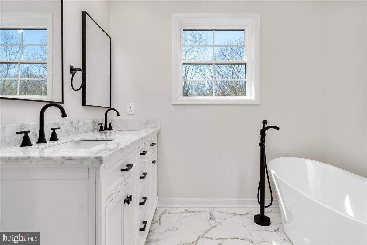 14630 Bain Road Hancock, MD 21750 - Photo 26 of 51 a bathroom with a tub sink and a mirror