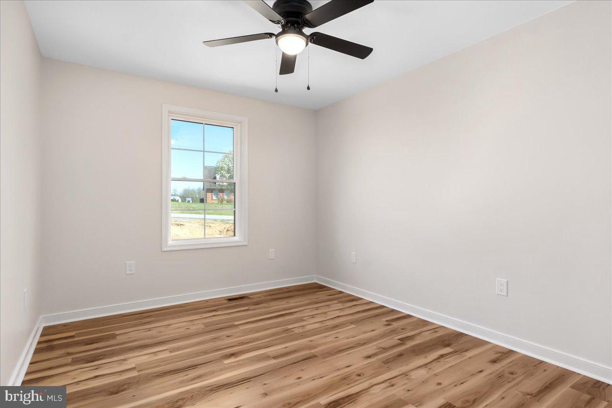 14630 Bain Road Hancock, MD 21750 - Photo 29 of 51 an empty room with wooden floor fan and windows