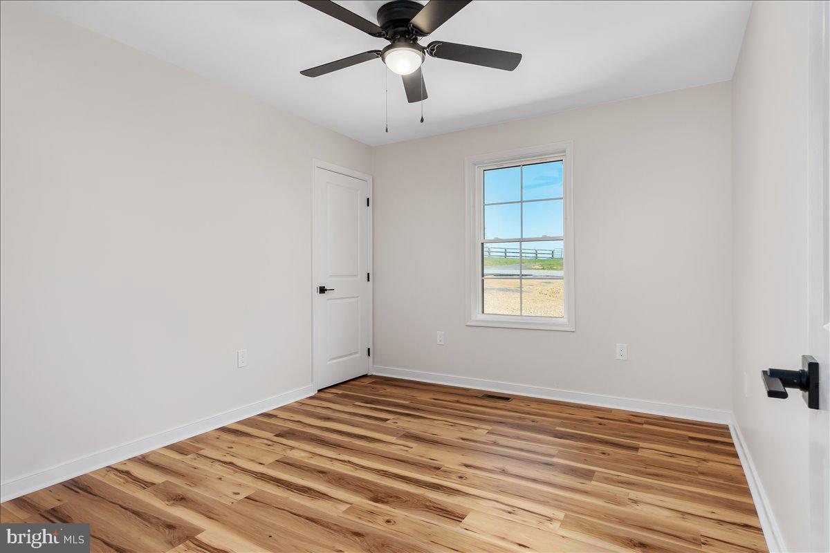 14630 Bain Road Hancock, MD 21750 - Photo 30 of 51 a view of empty room with wooden floor and fan