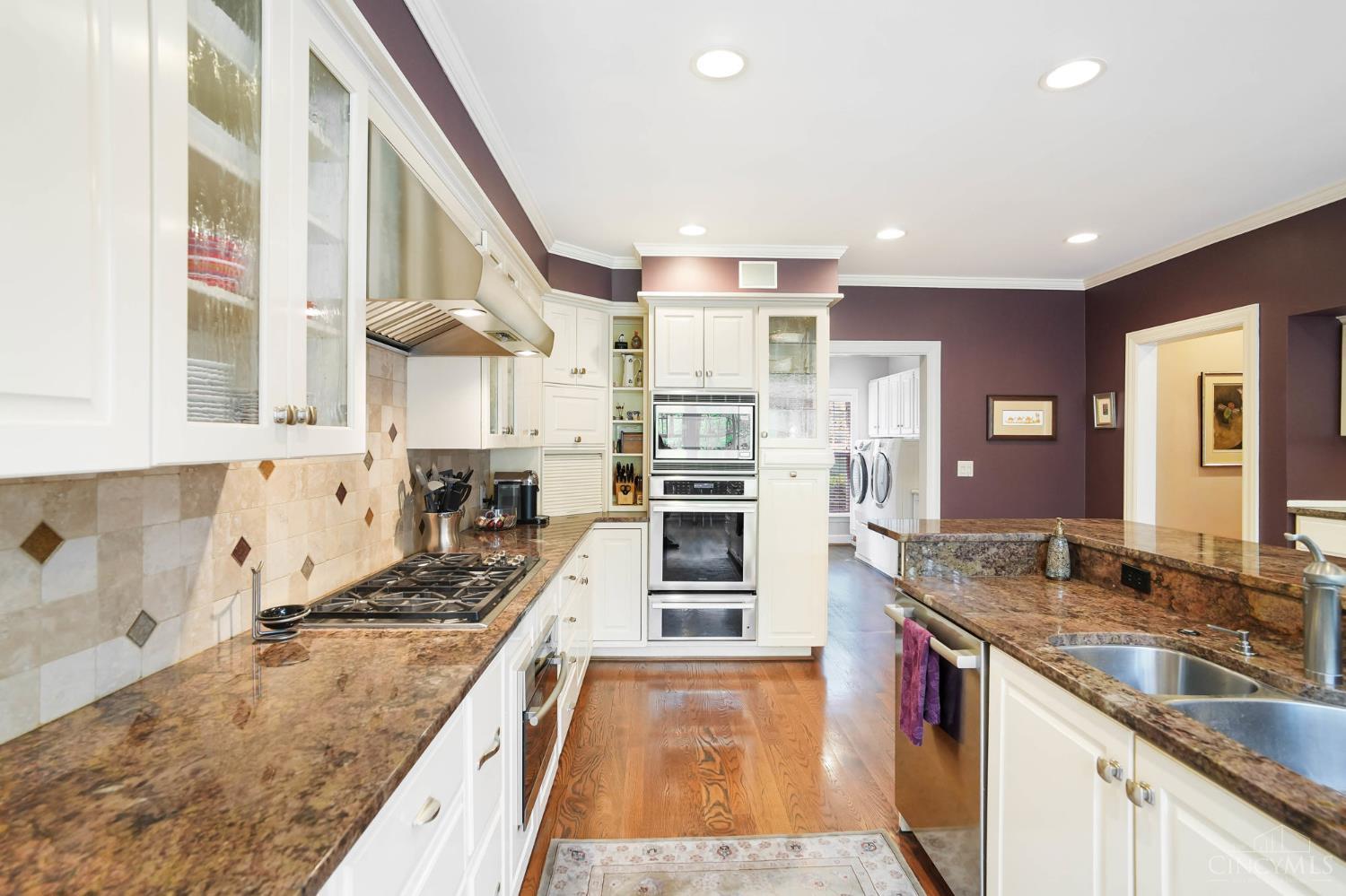 2780 Walsh Road Cincinnati, OH 45208 - Photo 12 of 68 The beautifully appointed, chef-inspired kitchen features custom cabinetry, expansive granite countertops and a generous center island designed for gathering. Premium appliances include a Wolf 36" 5-burner gas cooktop, a Thermador wall oven and microwave with warming drawer, Miele steam oven, Bosch dishwasher and a 48" SubZero built-in refrigerator. An oversized walk-in pantry provides exceptional storage, while a secondary serving bar and seamless connection to the family room and breakfast area enhance both everyday living and entertaining.