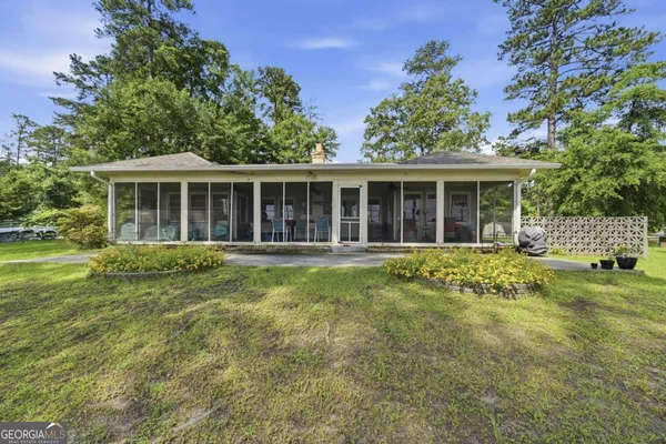 a view of a house with a backyard
