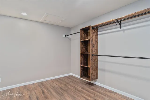 a view of walk in closet with empty racks