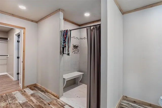 a bathroom with a shower and a sink
