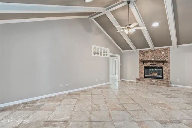 a view of an empty room with a fireplace