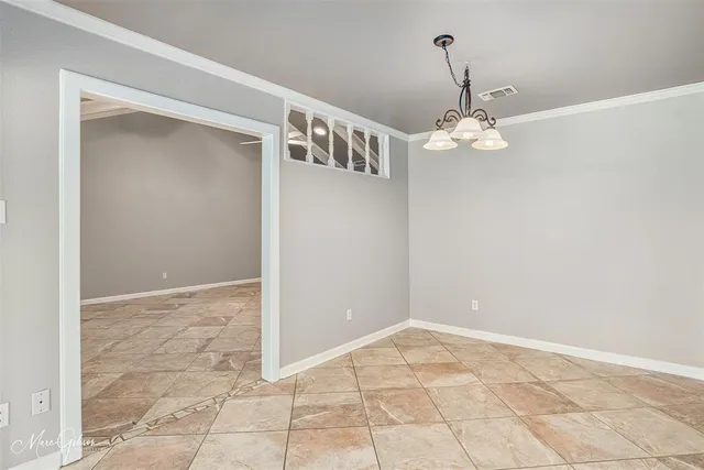 a view of a hallway with a chandelier fan