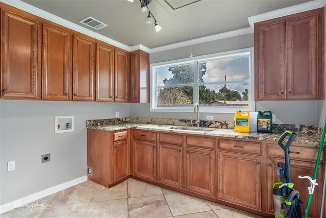 a kitchen with stainless steel appliances granite countertop a refrigerator and sink