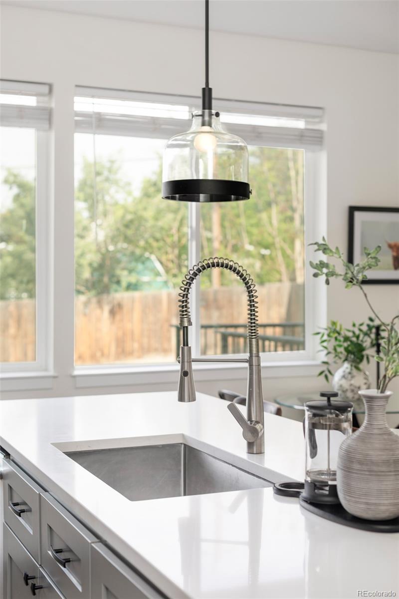 5230 Stuart Street Denver, CO 80212 - Photo 10 of 34 a kitchen with a large window and a sink