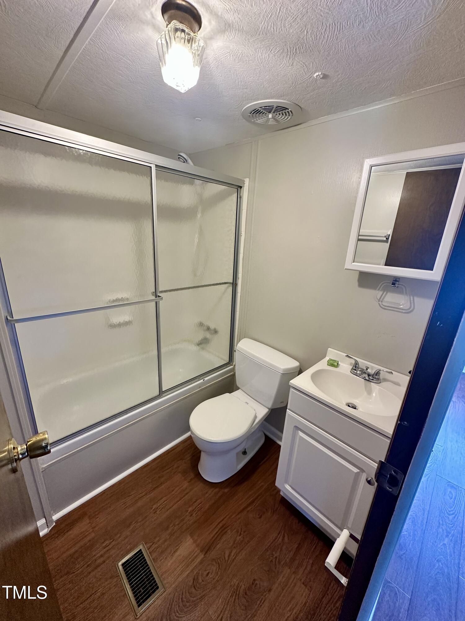 841 Chalybeate Springs Road Angier, NC 27501 - Photo 11 of 24 a bathroom with a toilet a sink and mirror