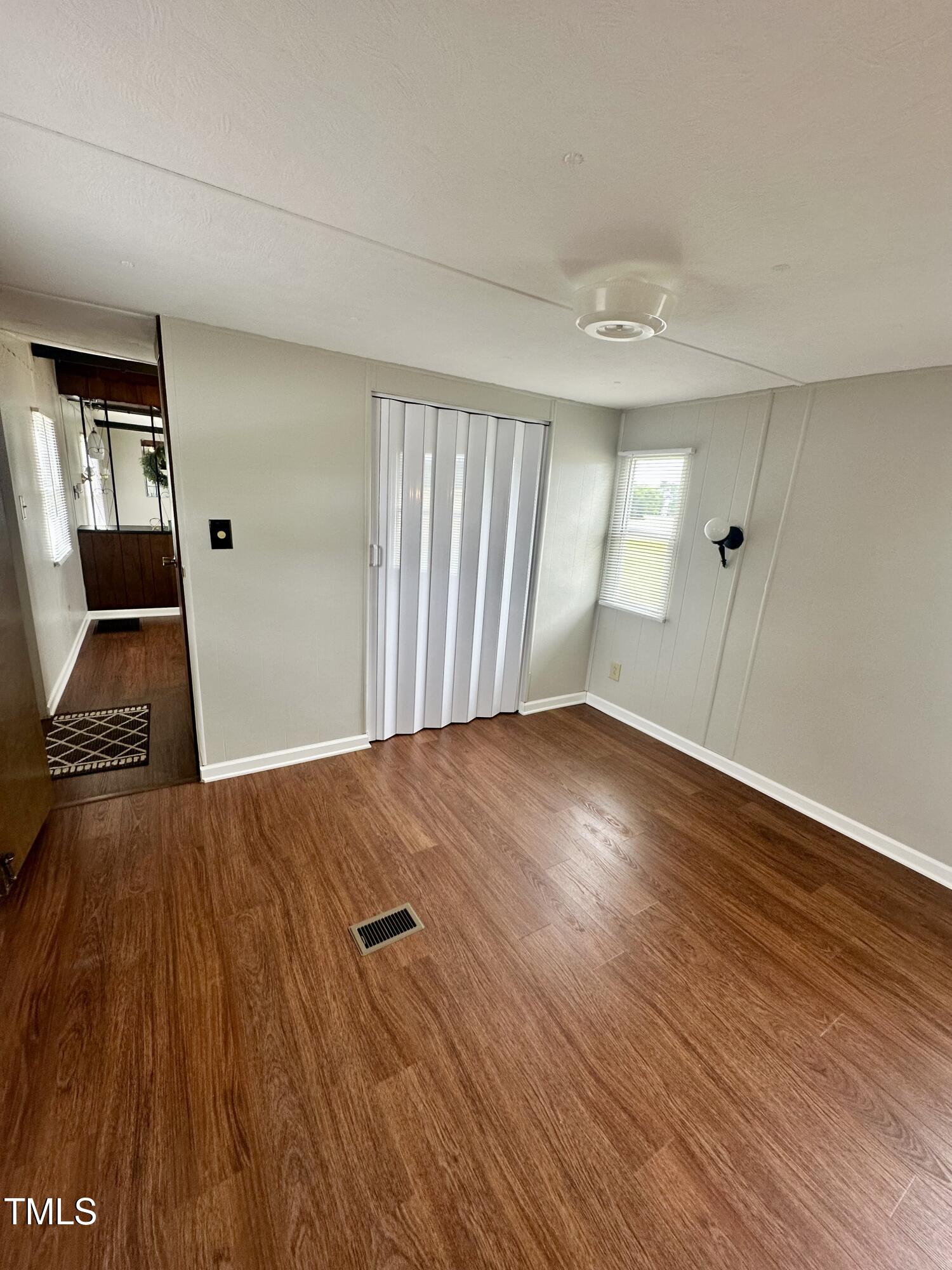 841 Chalybeate Springs Road Angier, NC 27501 - Photo 13 of 24 wooden floor in an empty room with a window