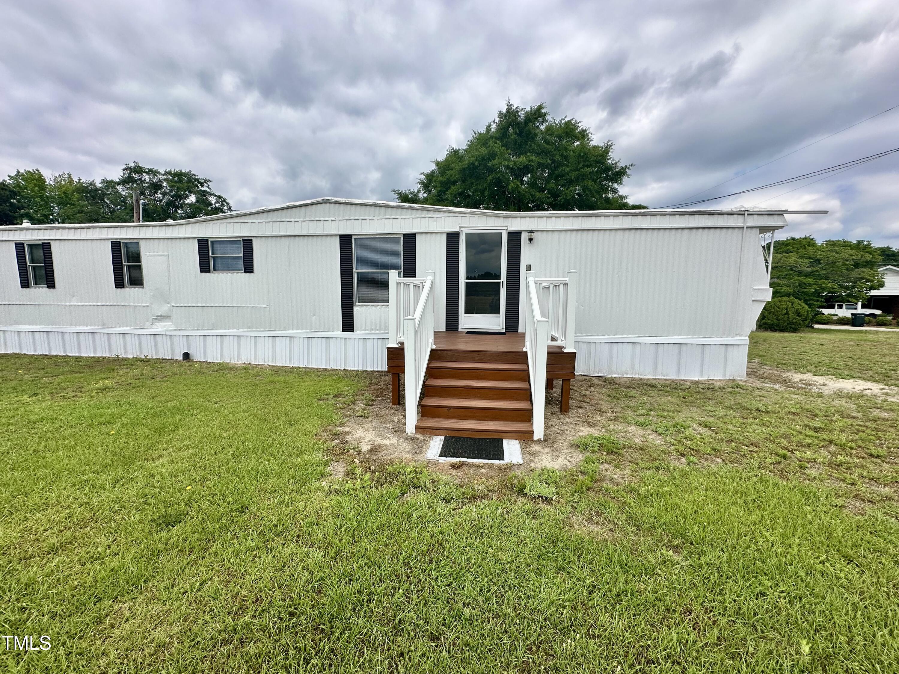 841 Chalybeate Springs Road Angier, NC 27501 - Photo 14 of 24 a house view with a garden space