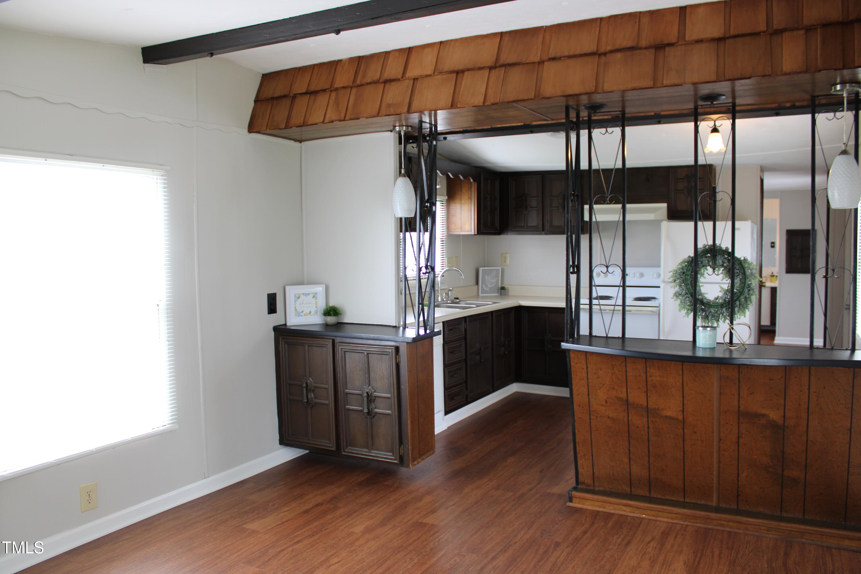 841 Chalybeate Springs Road Angier, NC 27501 - Photo 17 of 24 a kitchen with stainless steel appliances kitchen island a large counter space and wooden floor
