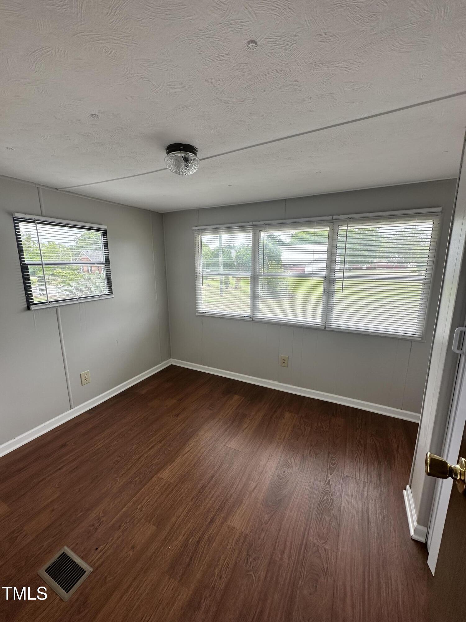 841 Chalybeate Springs Road Angier, NC 27501 - Photo 5 of 24 wooden floor in an empty room with a window