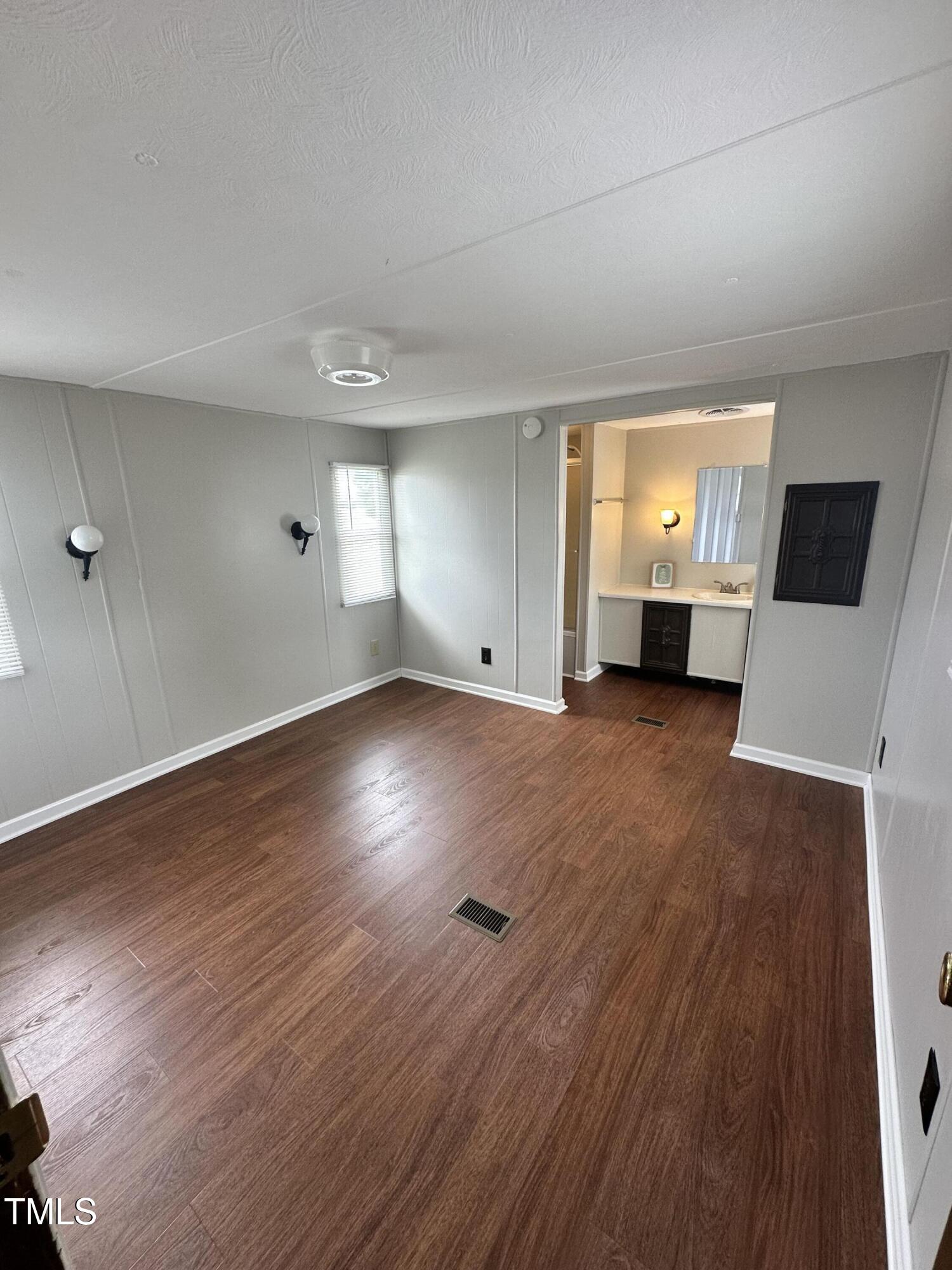 841 Chalybeate Springs Road Angier, NC 27501 - Photo 8 of 24 an empty room with wooden floor and windows