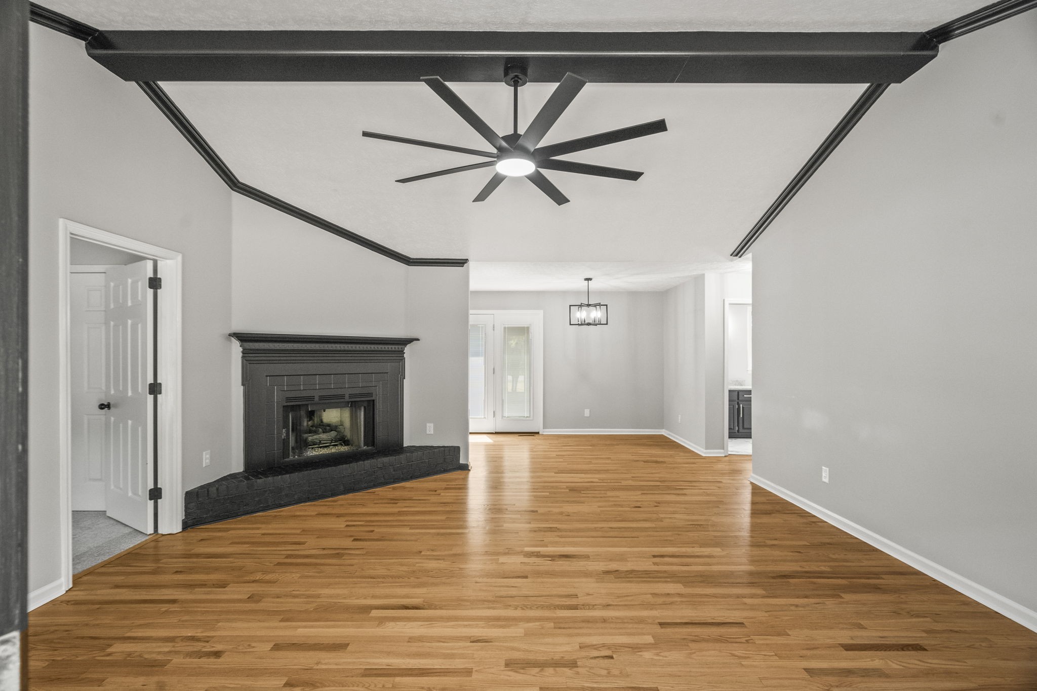 8861 Owens Chapel Road Springfield, TN 37172 - Photo 5 of 22 a view of an empty room with a fireplace and a chandelier fan