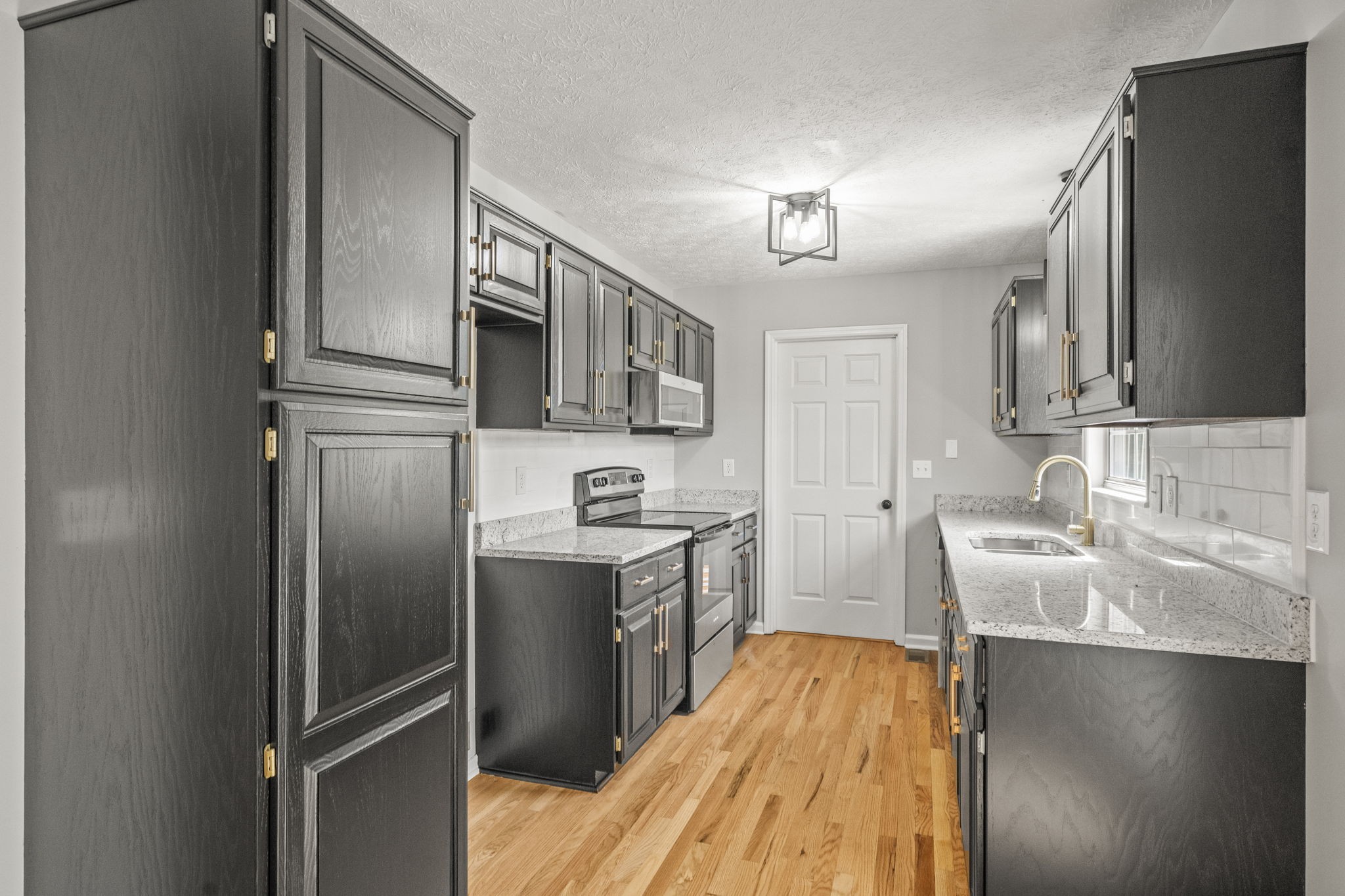 8861 Owens Chapel Road Springfield, TN 37172 - Photo 8 of 22 a kitchen with stainless steel appliances granite countertop a sink stove and refrigerator